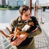 Man carrying a dog.