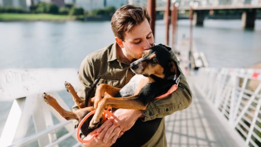 Man carrying a dog.